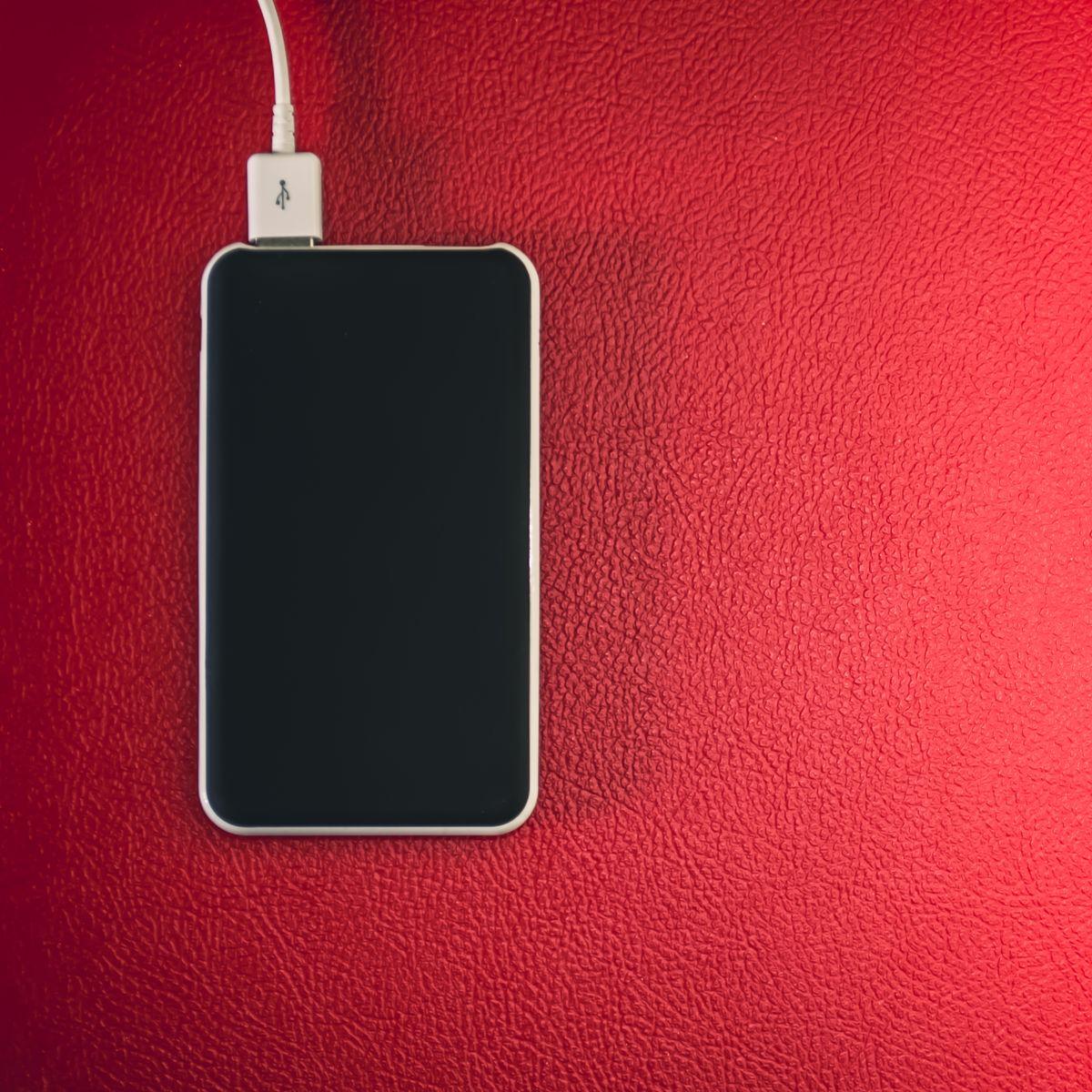 A phone charging on a wireless pad